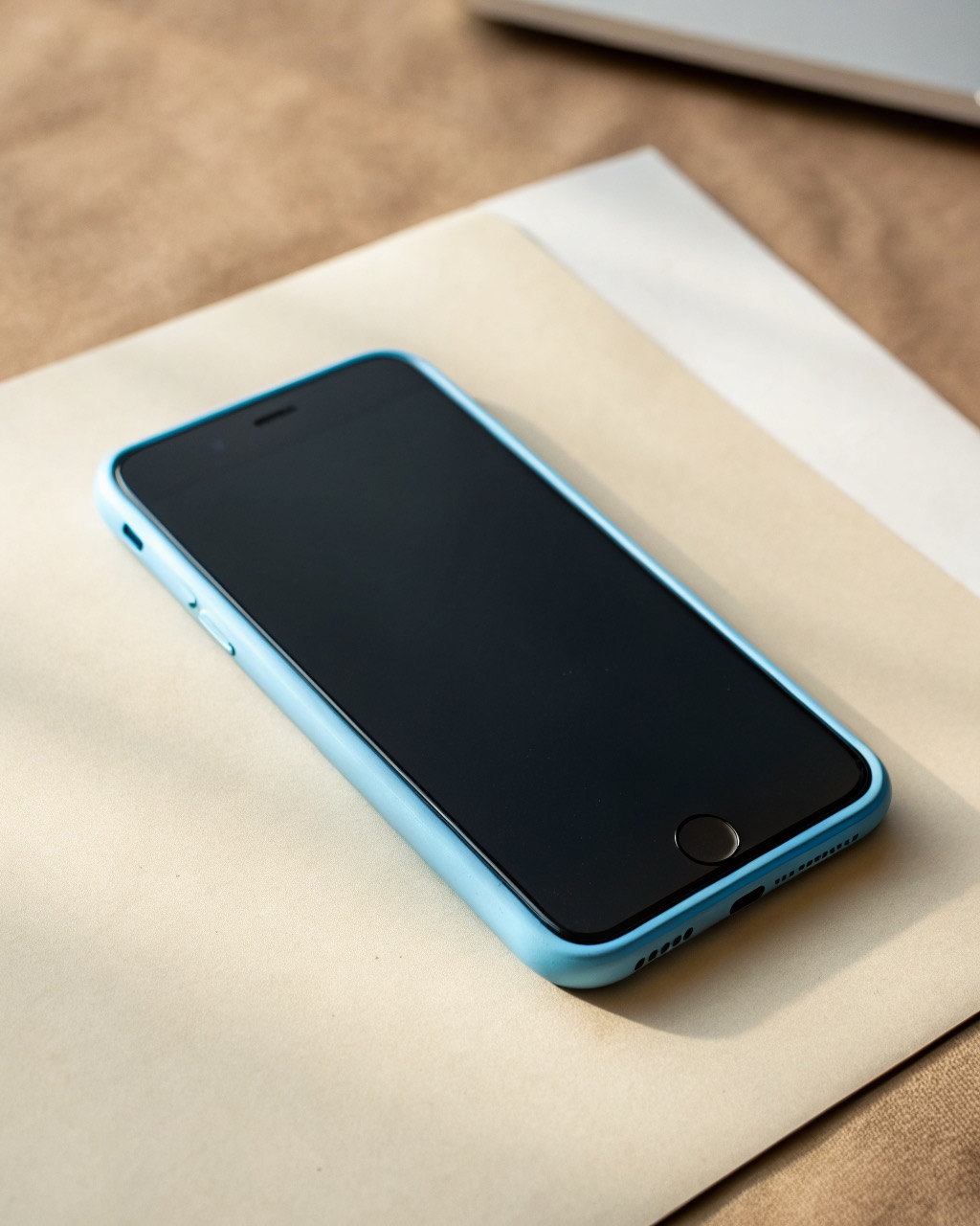 Sky-blue smartphone shown front and back, flat 120 Hz OLED screen, dual rear camera in a slim module, matte plastic frame, completely unbranded with no logos