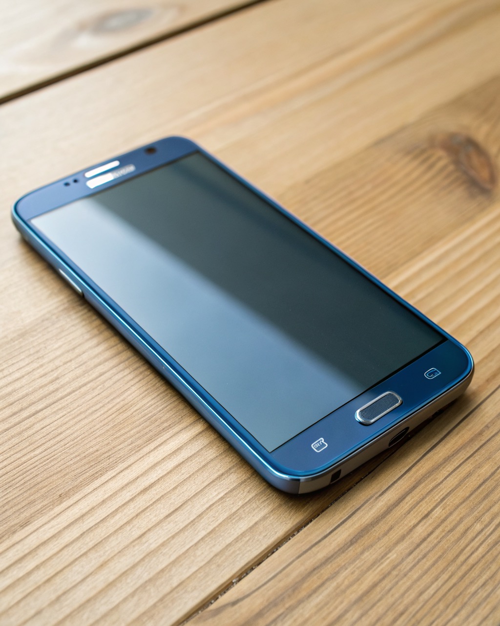 Large deep-blue glass smartphone shown front and three-quarter angle, big flat screen, four rear cameras in a vertical strip, no branding
