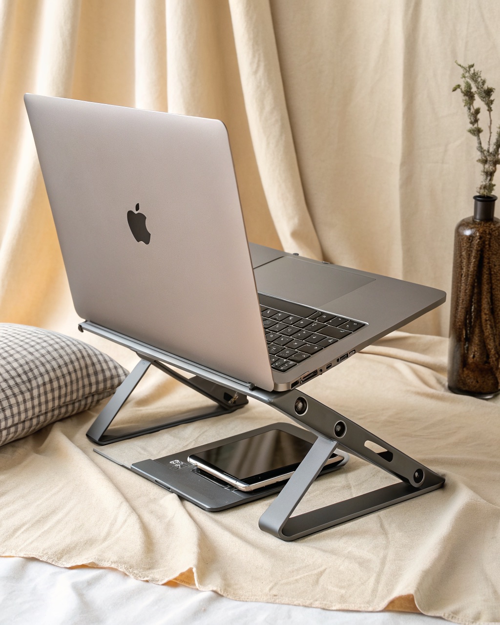 Graphite powder-coated bent-steel laptop stand with an open frame, holding a laptop raised above a desk